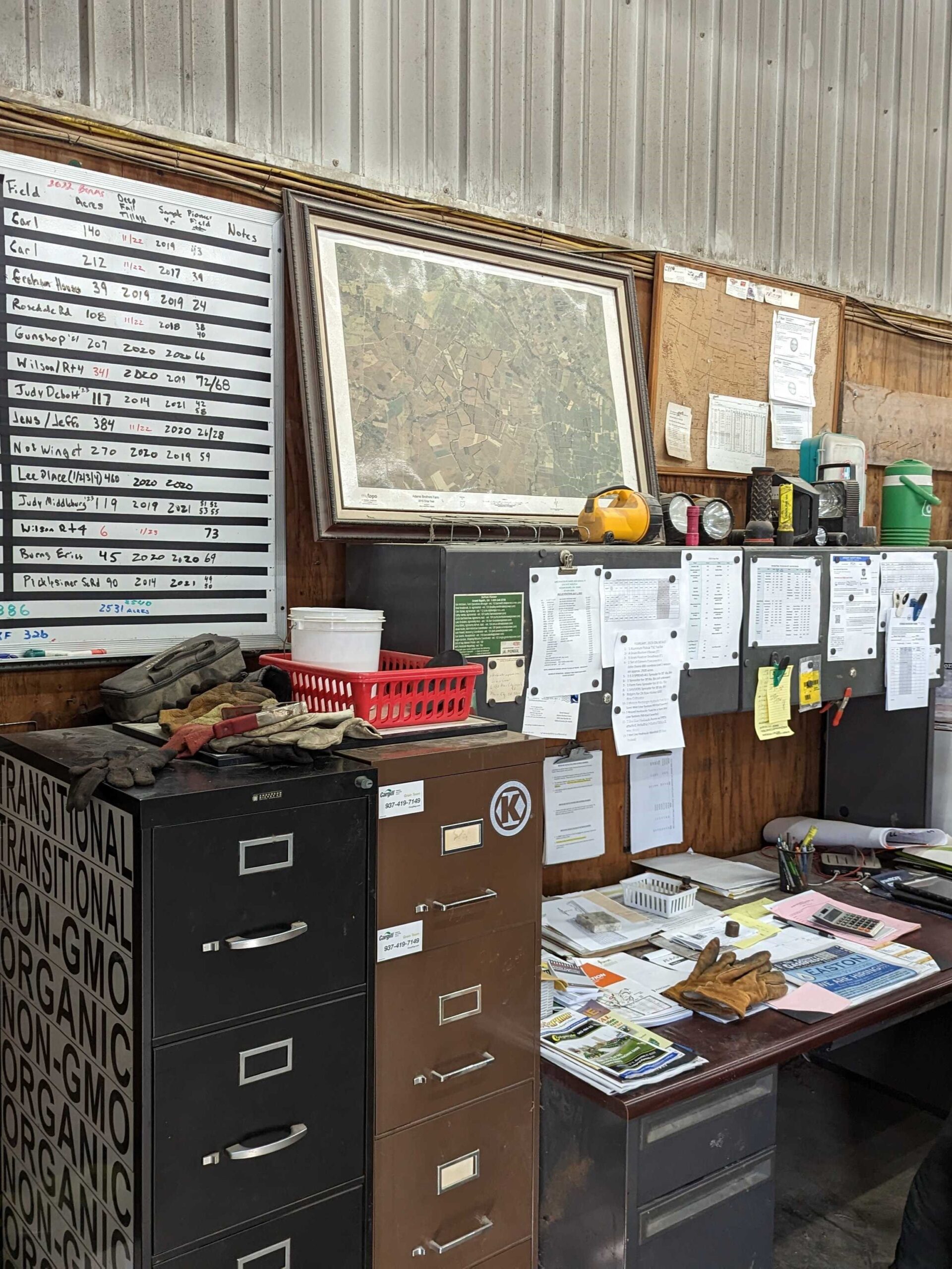 The farm office, with charts and a map on the wall above filing cabinets
