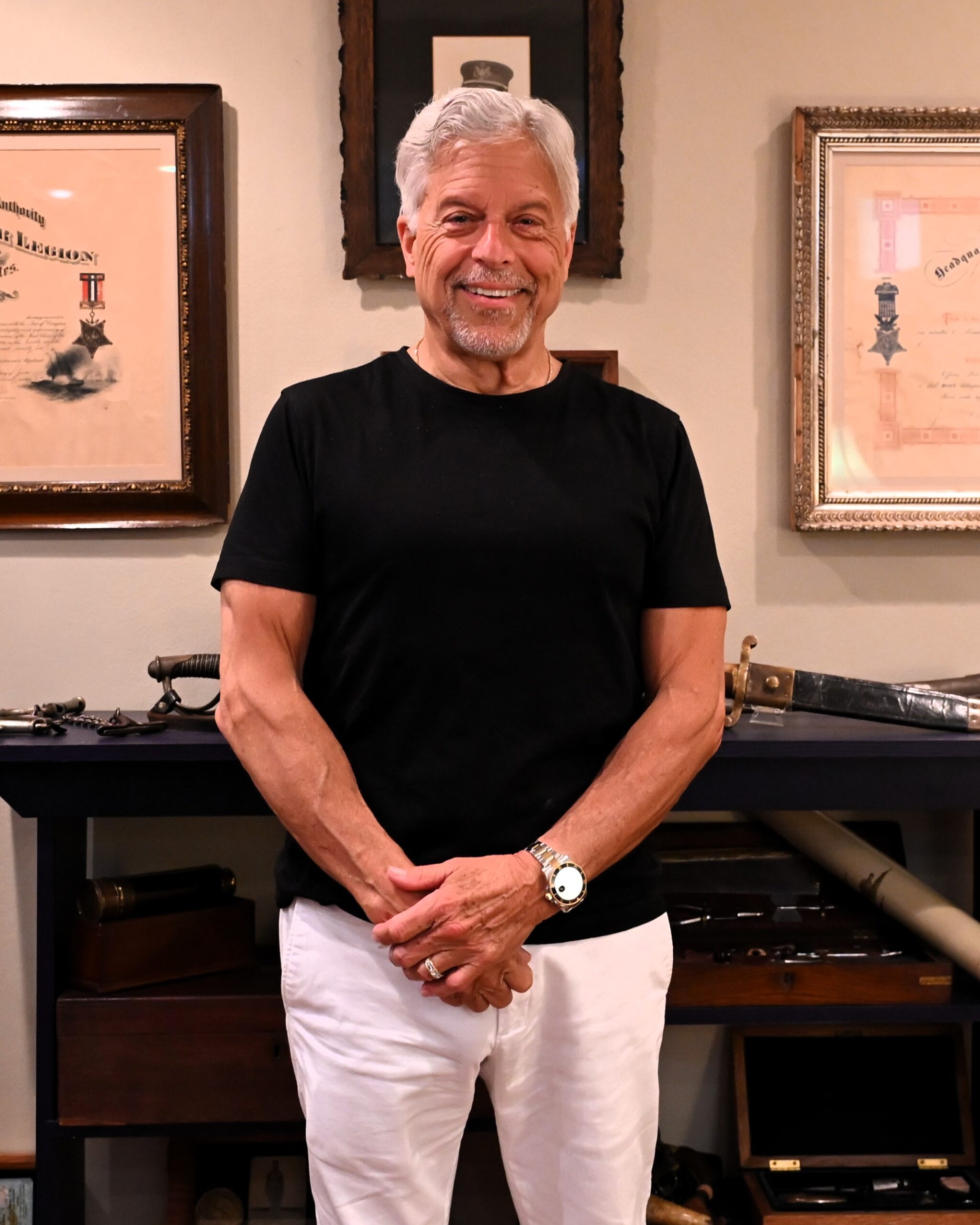 Bill Given standing in the room that houses his military history collection