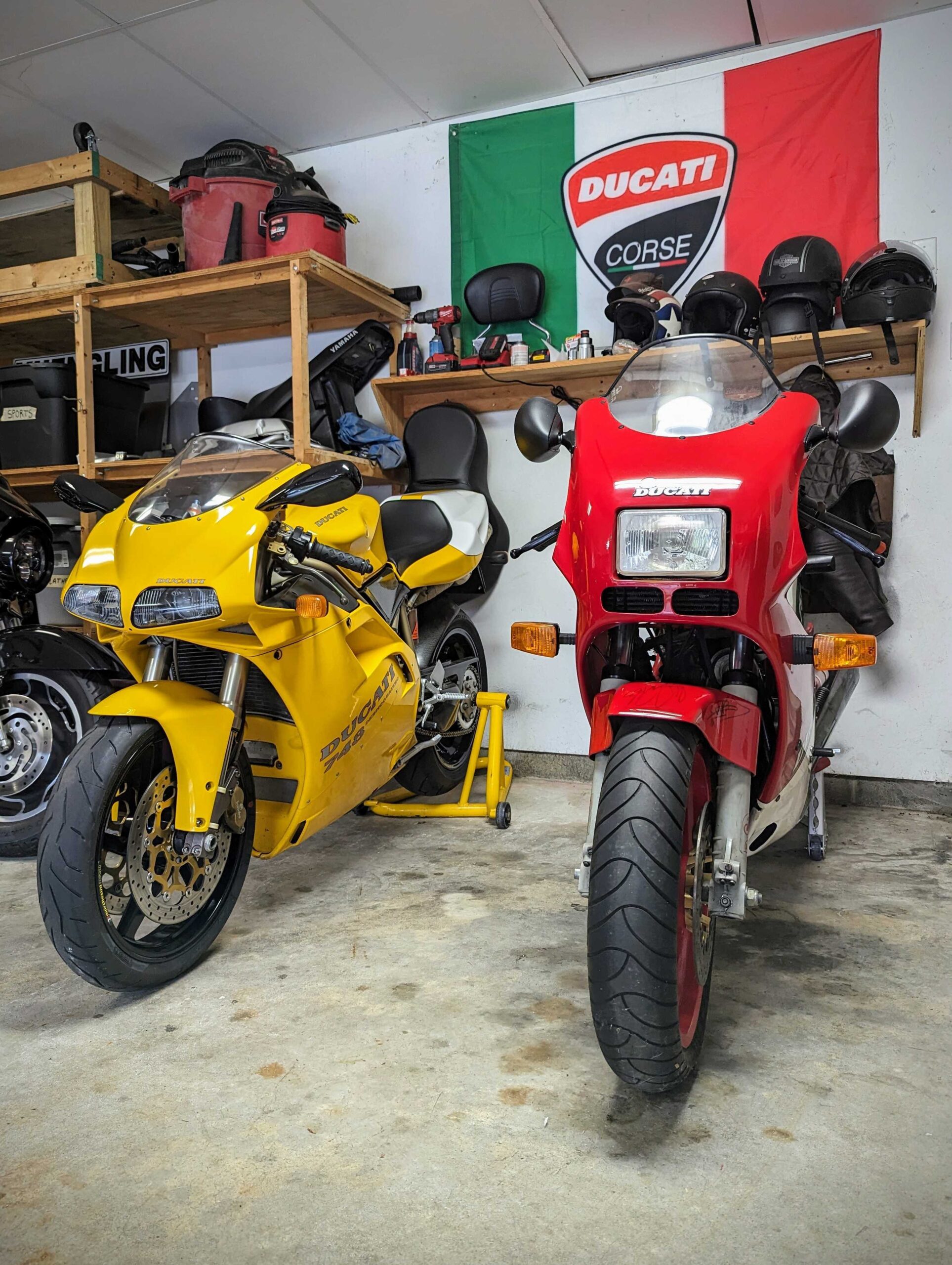 A yellow Ducati and a red Ducati parked in Eric's garage