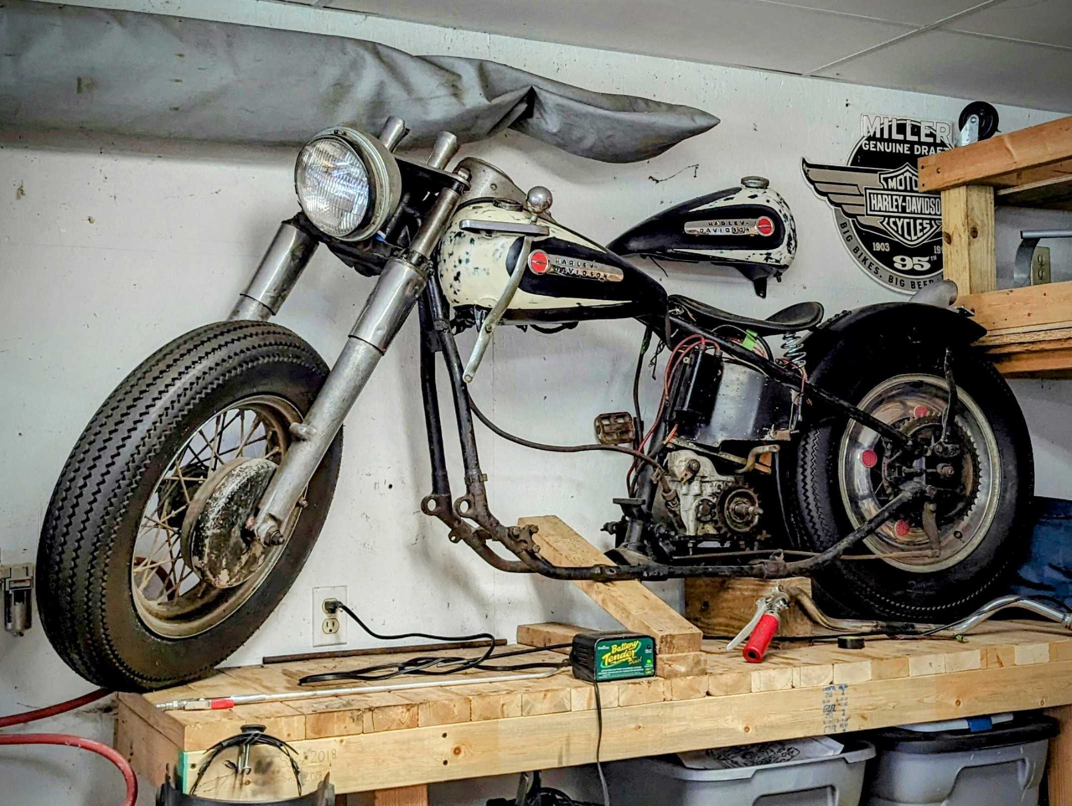 A vintage motorcycle being restored on a workbench