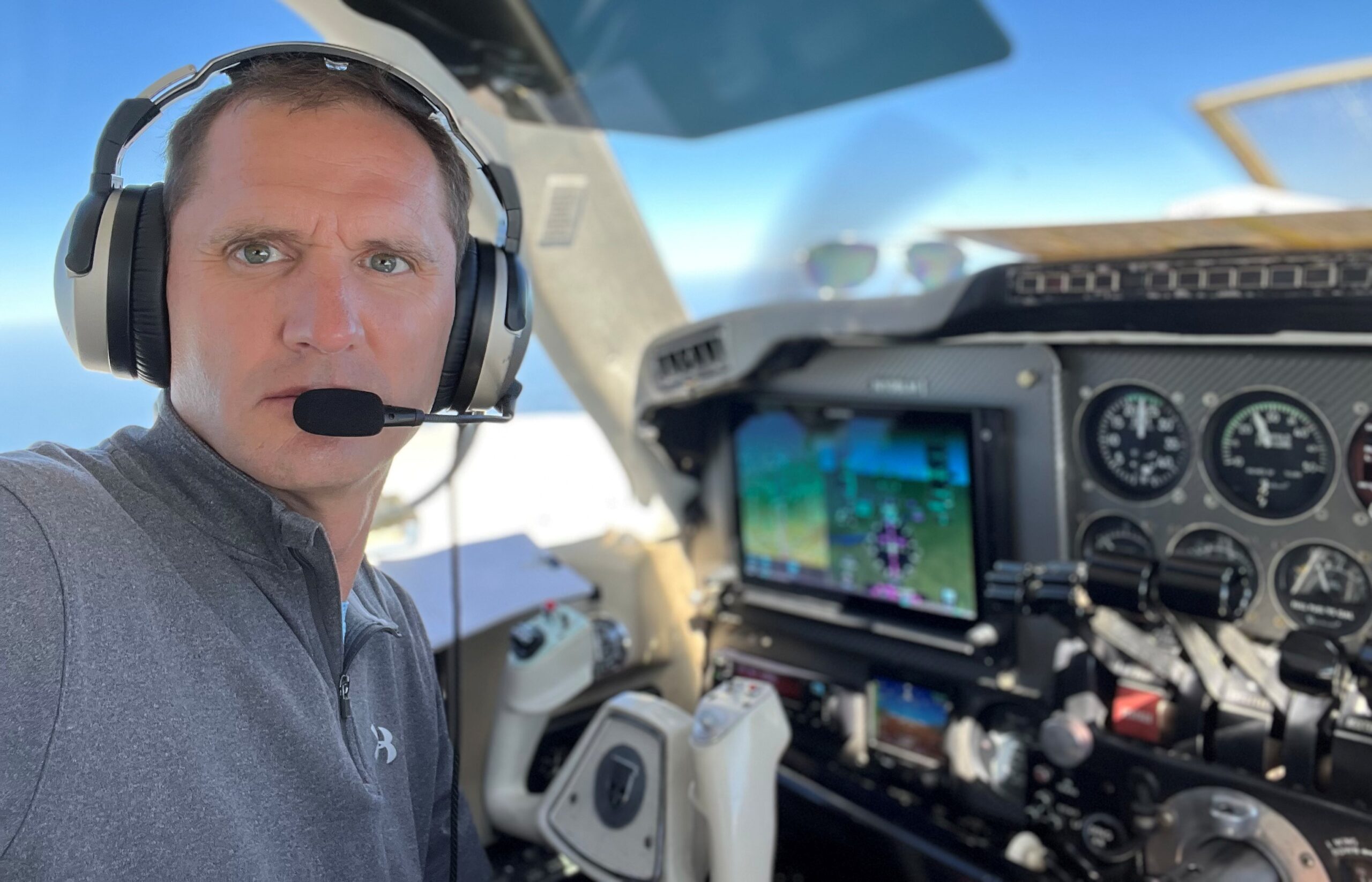 Steve Wieringa wearing a headset in the cockpit of a small aircraft