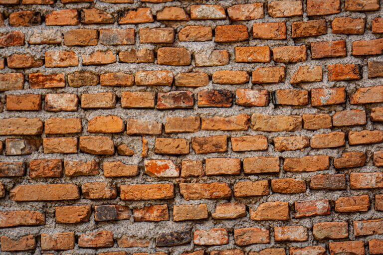 A weathered red brick wall