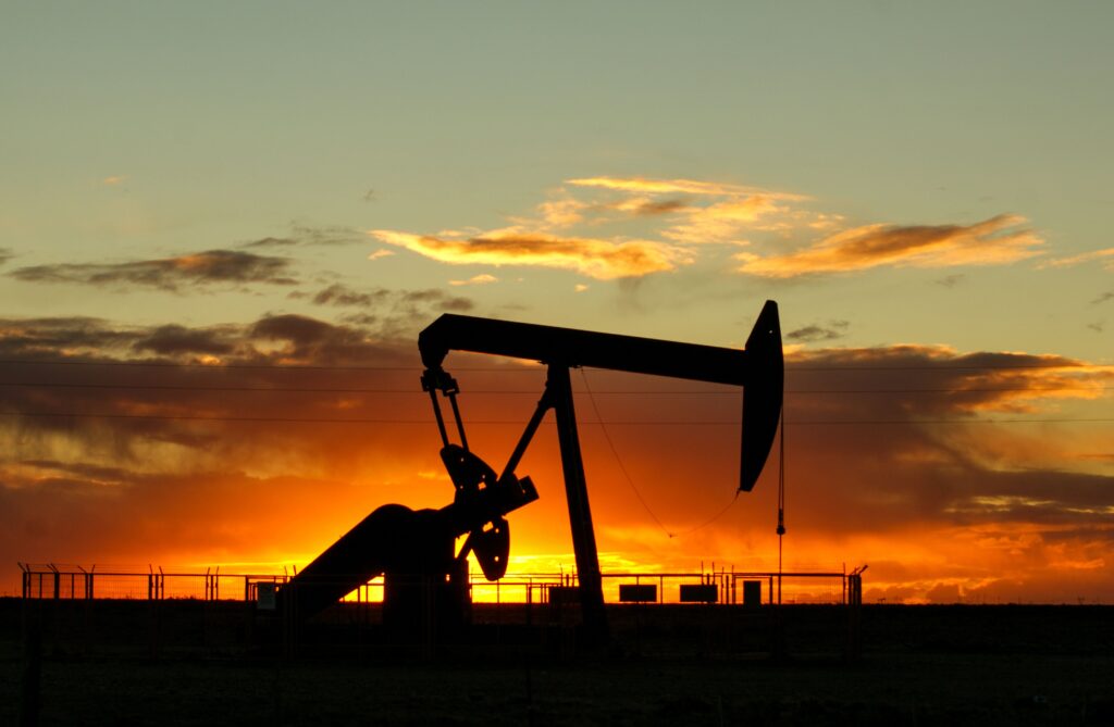An oil pumpjack silhouetted at sunset